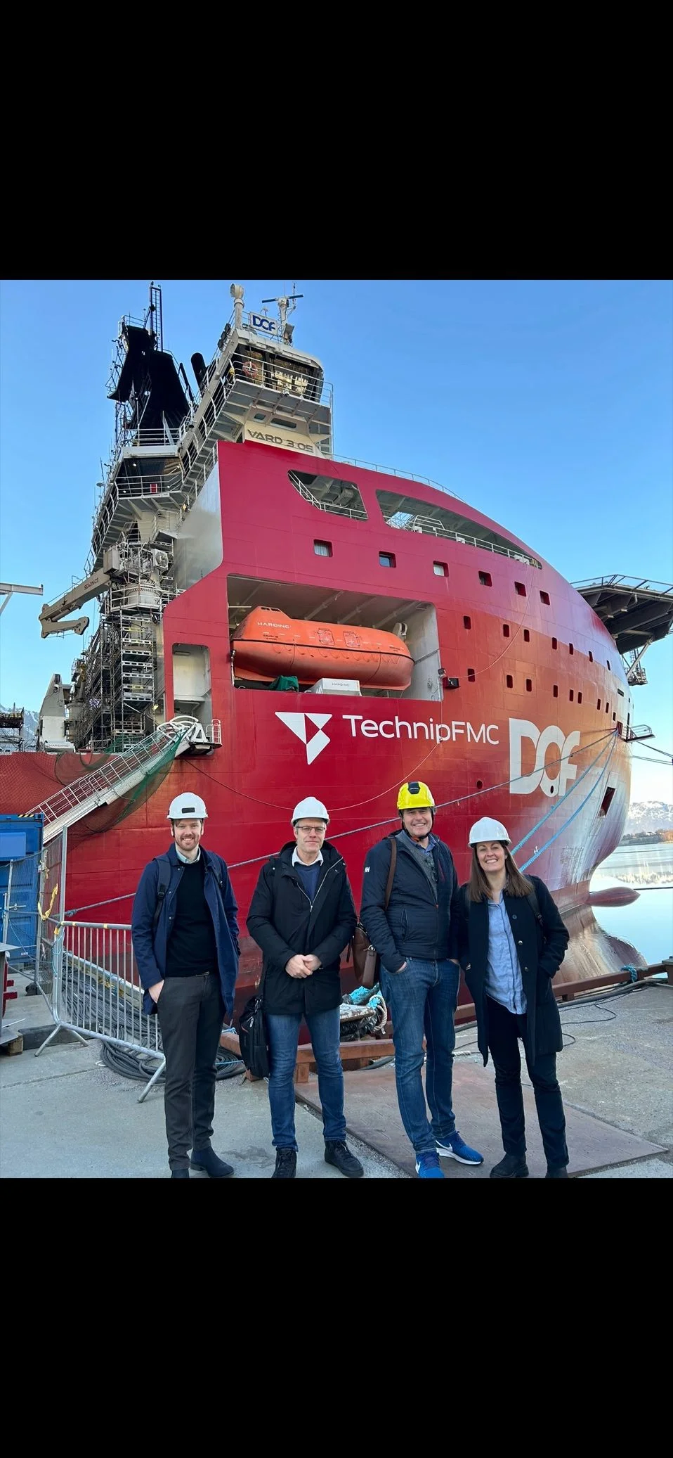 Visitors standing in front of a DOF vessel.