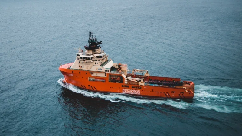 Orange offshore support vessel underway at sea, from the article shared by Dipai.
