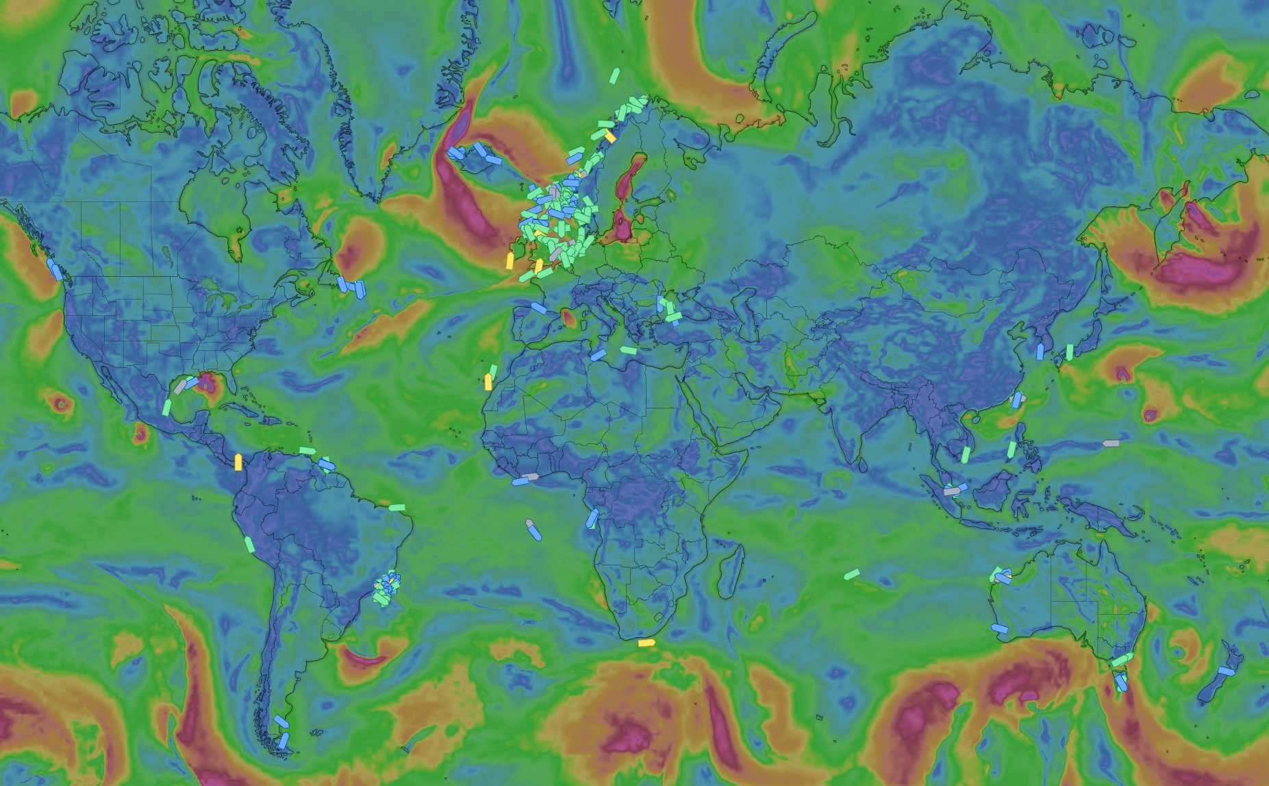 Fleet overview world map showing vessel positions coloured by status over a global wind and weather layer.
